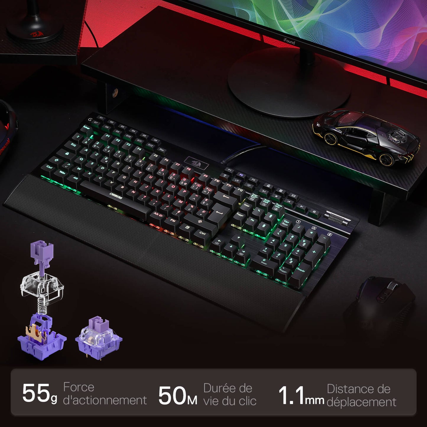 Gaming keyboard with RGB lighting on a desk setup, including a monitor and mouse.