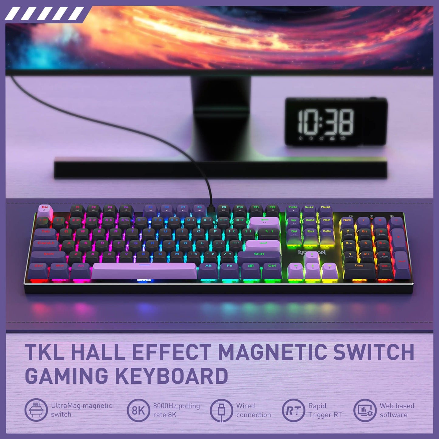 Gaming keyboard with colorful backlighting in front of a computer monitor displaying a space scene.