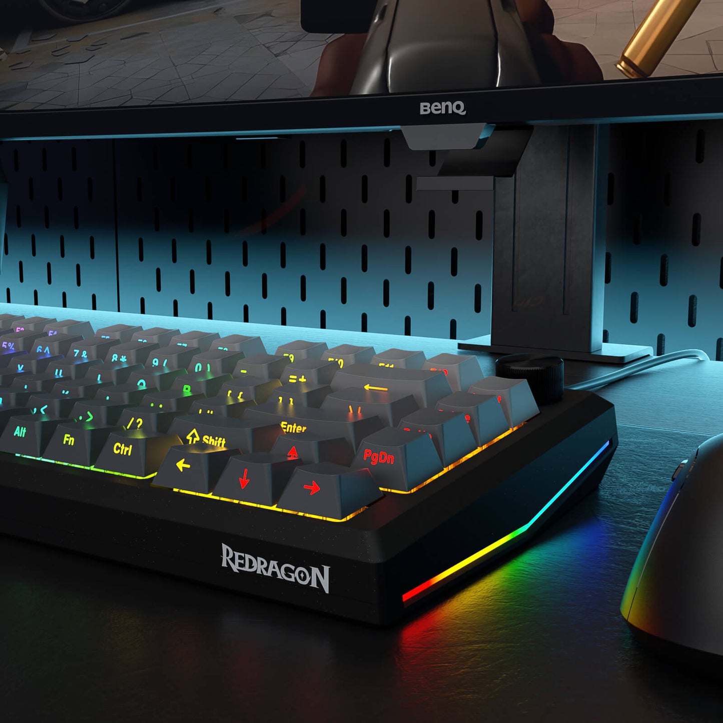 Redragon keyboard with RGB lighting on a desk, featuring a BenQ monitor in the background.