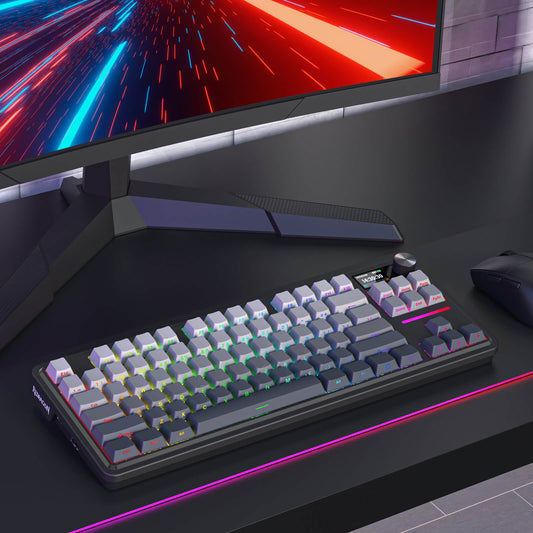 Redragon K743 PRO Gaming setup with keyboard, mouse, and monitor on a dark surface