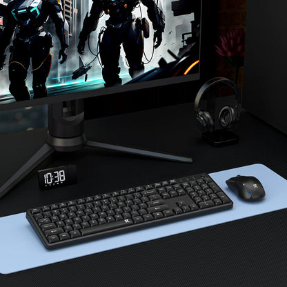 A wireless keyboard and mouse set is displayed in a gaming setup, paired with a monitor, desk clock, and headphones on a light blue desk mat.