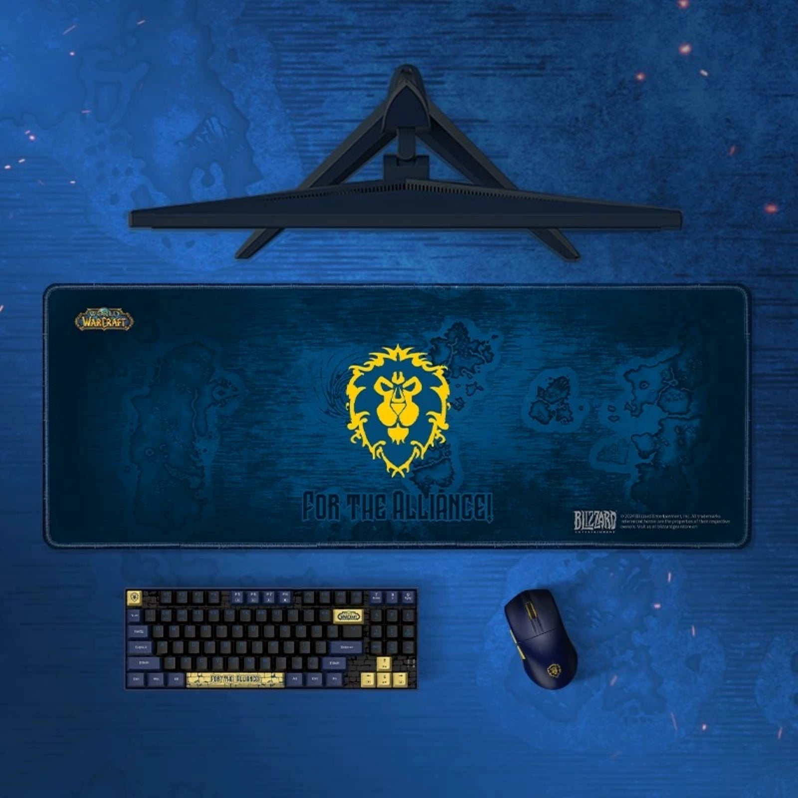 Gaming setup with mouse pad, keyboard, and mouse on a blue surface