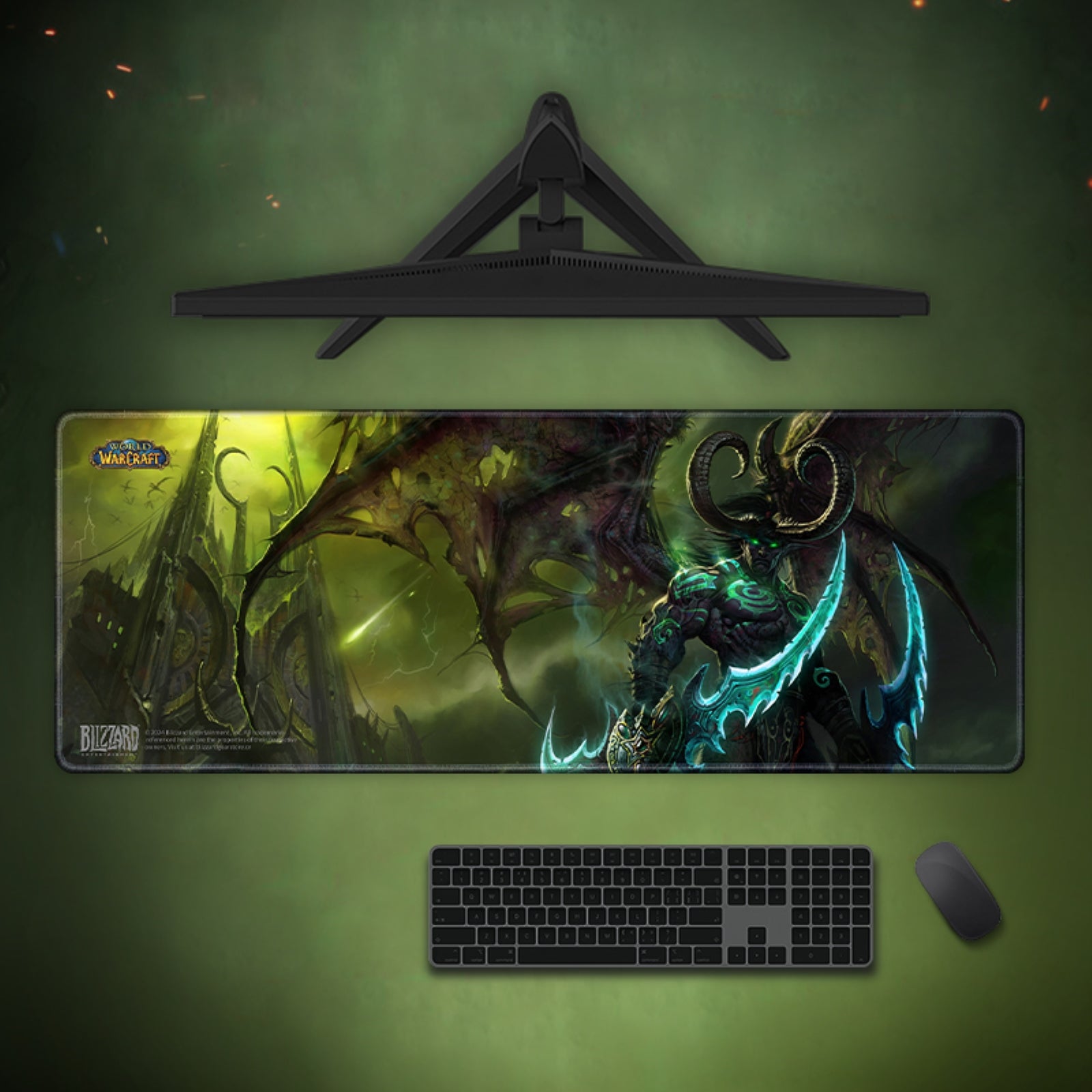 Gaming setup with a large mouse pad featuring a fantasy design, keyboard, and mouse on a green background.