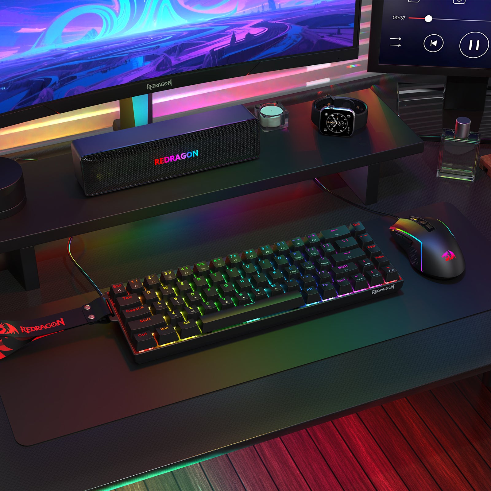 Showcases a Redragon gaming peripheral setup (keyboard, mouse, and speaker) placed on a desk, paired with a monitor