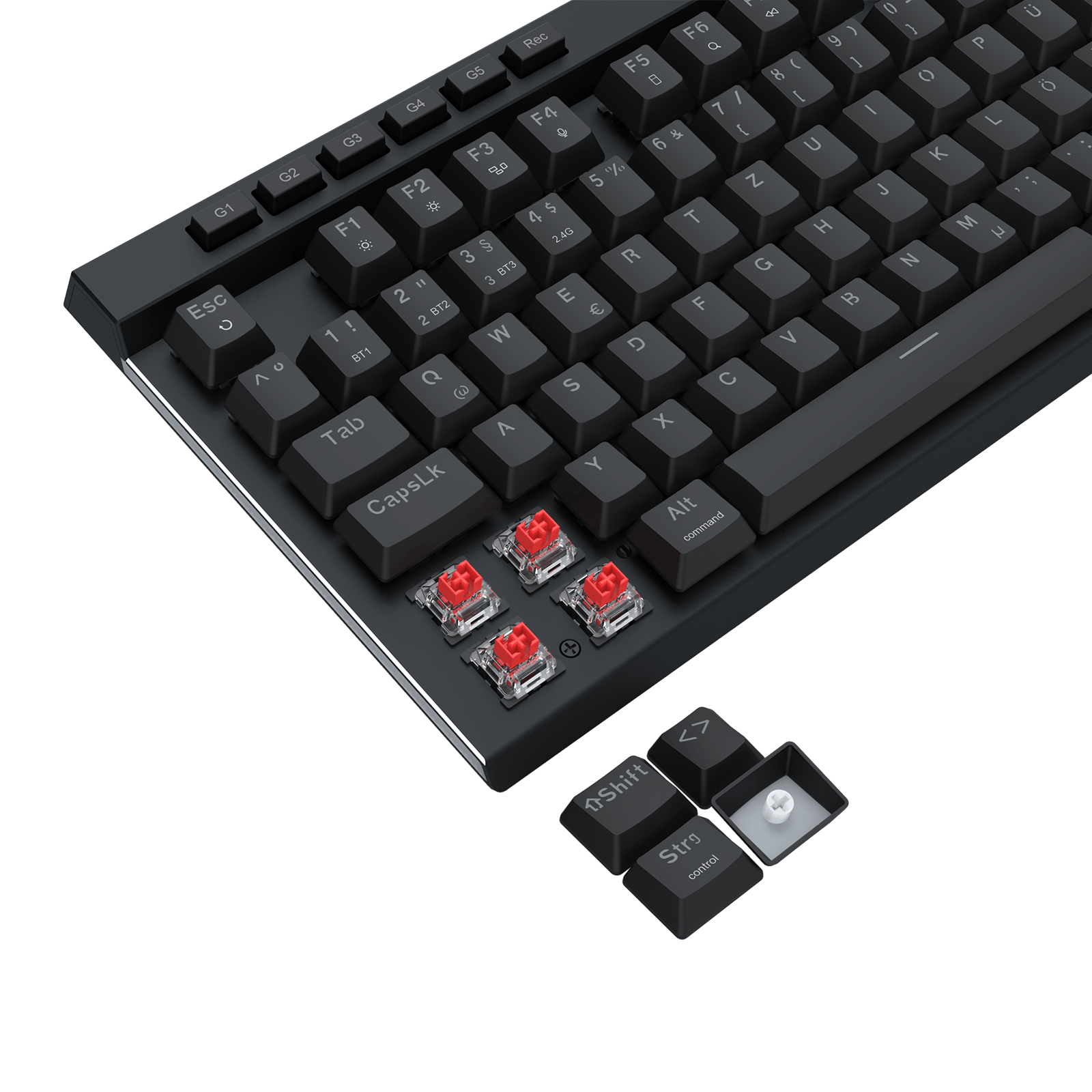 A close-up of a black mechanical keyboard with silver trim and four exposed red switch capsules near the bottom left, plus a small detached keycap cluster on a black background.