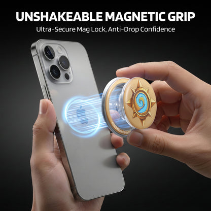 Against a dark backdrop, this graphic highlights an UNSHAKEABLE MAGNETIC GRIP accessory: hands attach a Hearthstone sun-emblem disc to a phone, with glowing blue magnetic effects emphasizing its "Ultra-Secure Mag Lock"—promising anti-drop confidence while showcasing the game’s iconic design.