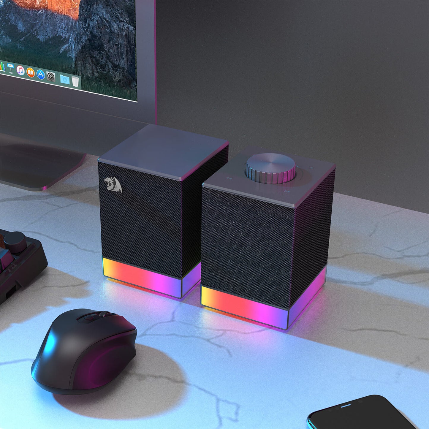 Gaming setup with RGB-lit speakers and mouse on a desk.
