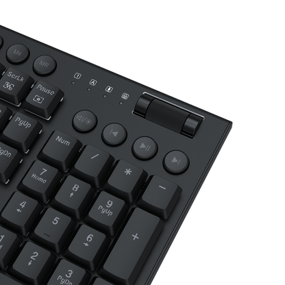 Close-up of a black mechanical keyboard showing the number pad, control buttons, and a slider switch on a black background.