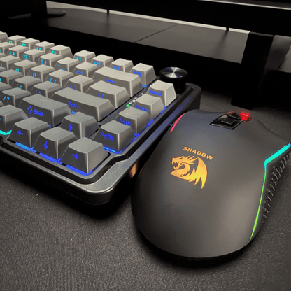 Gaming keyboard and mouse set with 'Shadow' branding on a dark surface