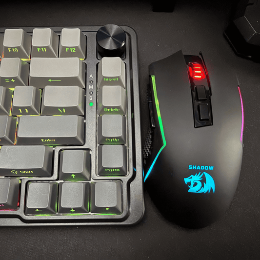Gaming keyboard and mouse set on a dark surface