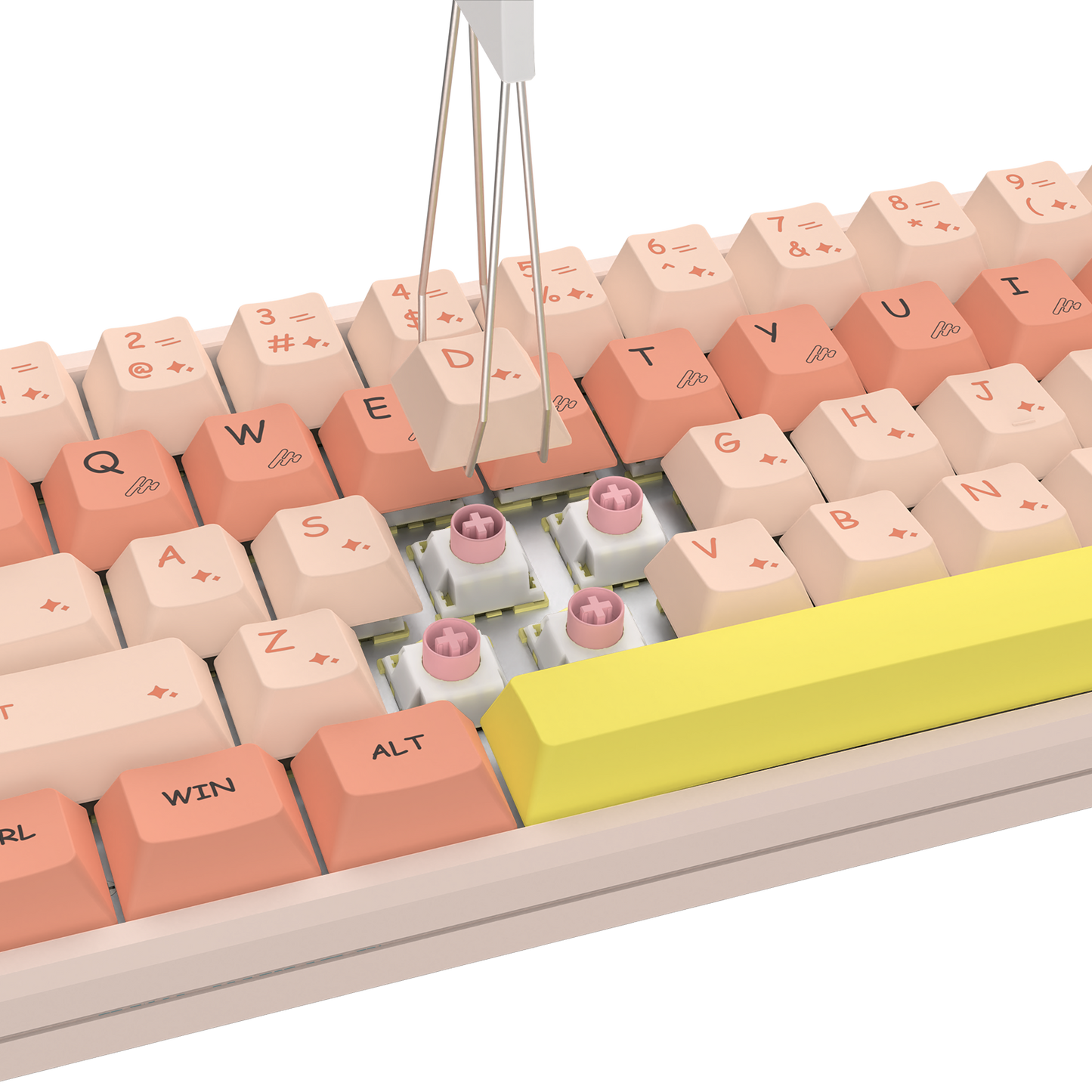 A close-up of a mechanical keyboard with pastel peach, cream, and coral keycaps, a large bright yellow spacebar, and visible pink switch capsules in the switch area. A metal key-stripping tool is positioned above the keyboard against a clean white background.