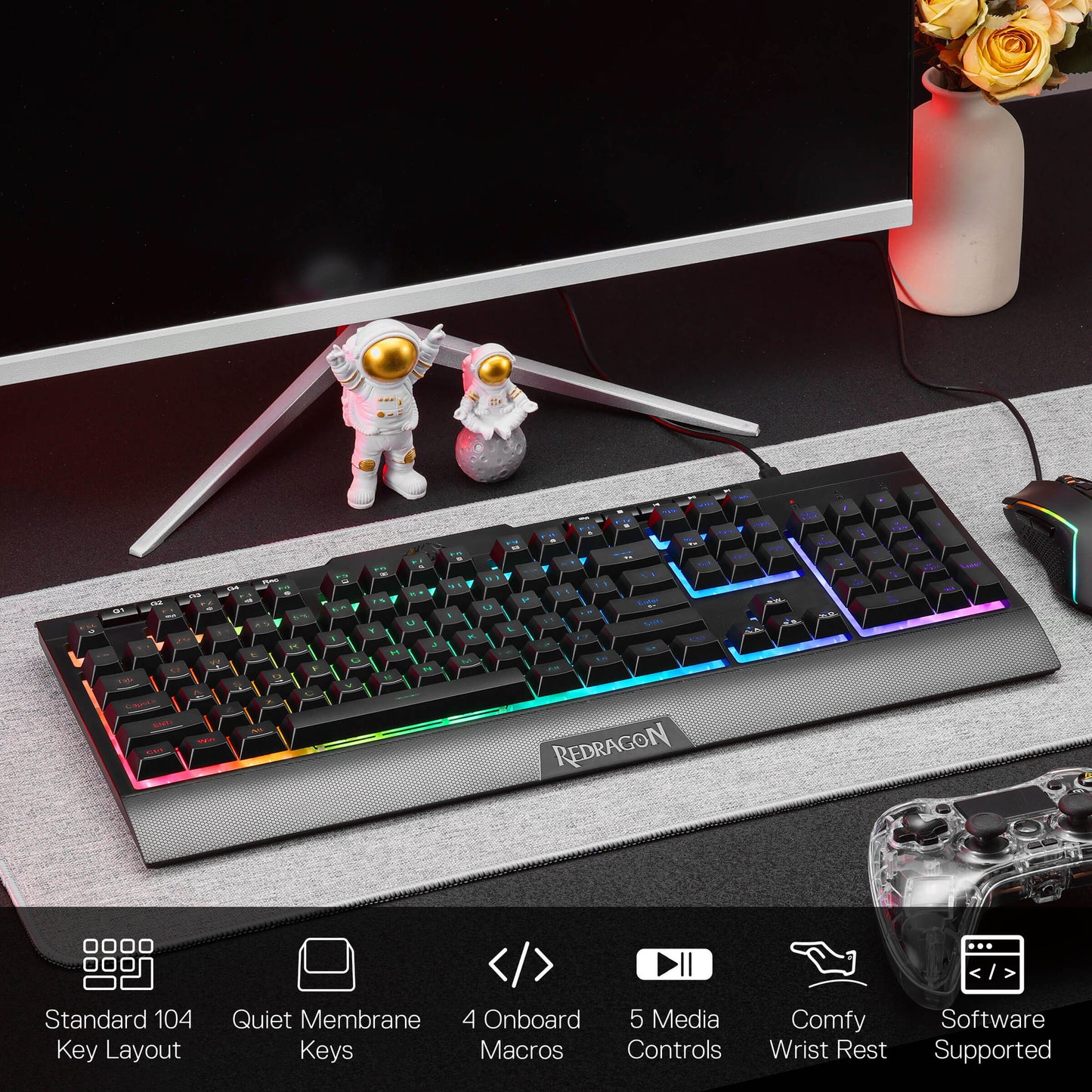 Redragon S151 Gaming keyboard on a desk with monitor, figurines, and decorative elements.