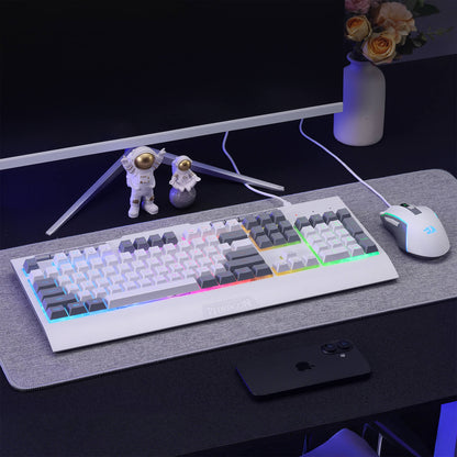 Mechanical keyboard with RGB lighting on a desk with a computer monitor, mouse, and phone.