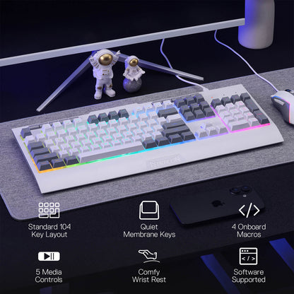 Mechanical keyboard on a desk with astronaut figurines and computer monitor