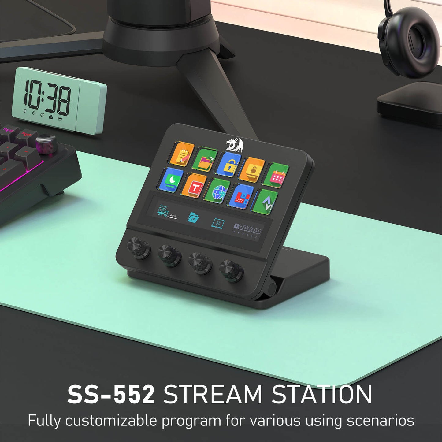 Redragon SS-552 Stream Station on a desk with a digital clock and headphones in the background