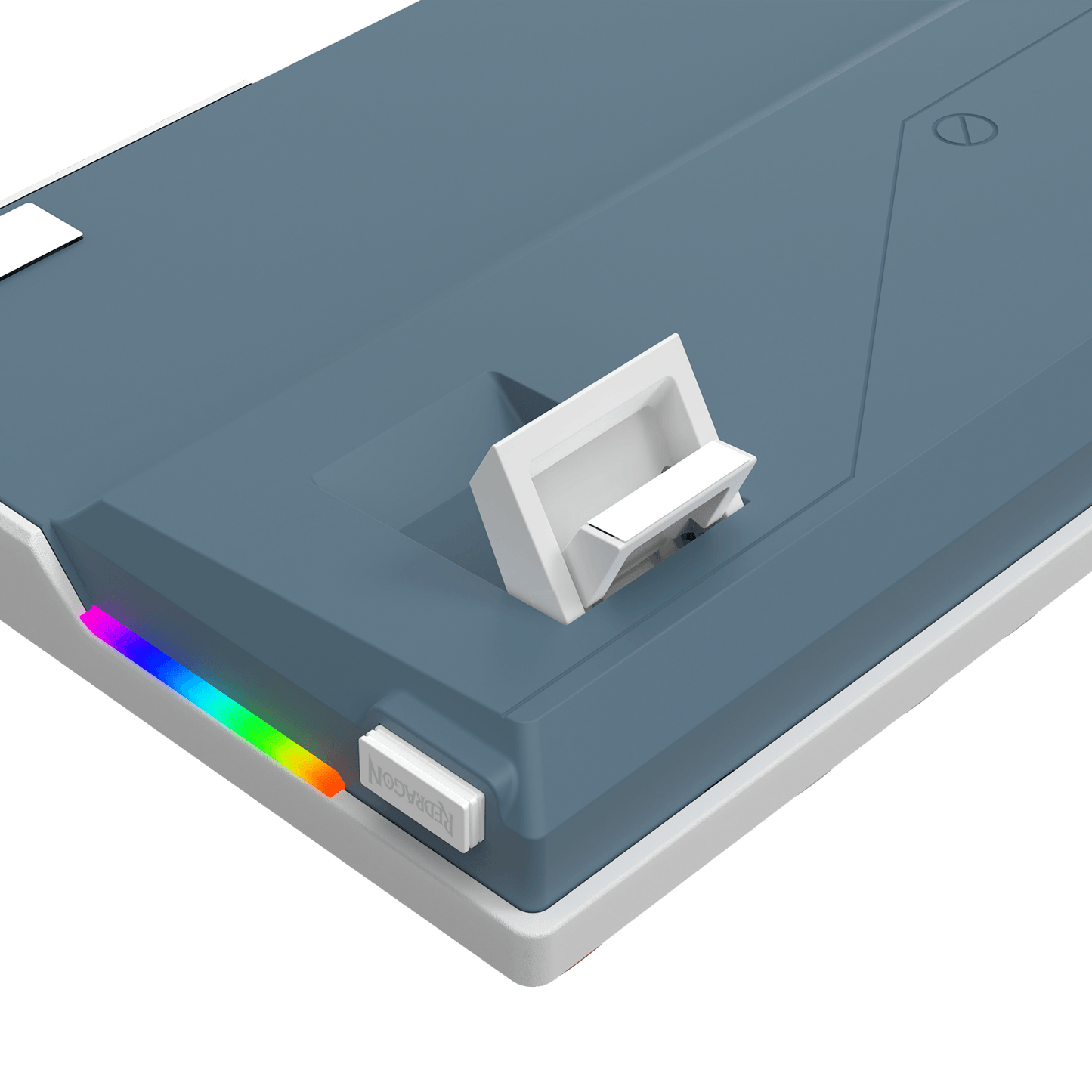 A close-up of a slate blue and white electronic device, likely a power bank or charging hub, featuring a white latch on top, a small white button, and a vibrant RGB rainbow light strip along the edge, shown against a solid black background.