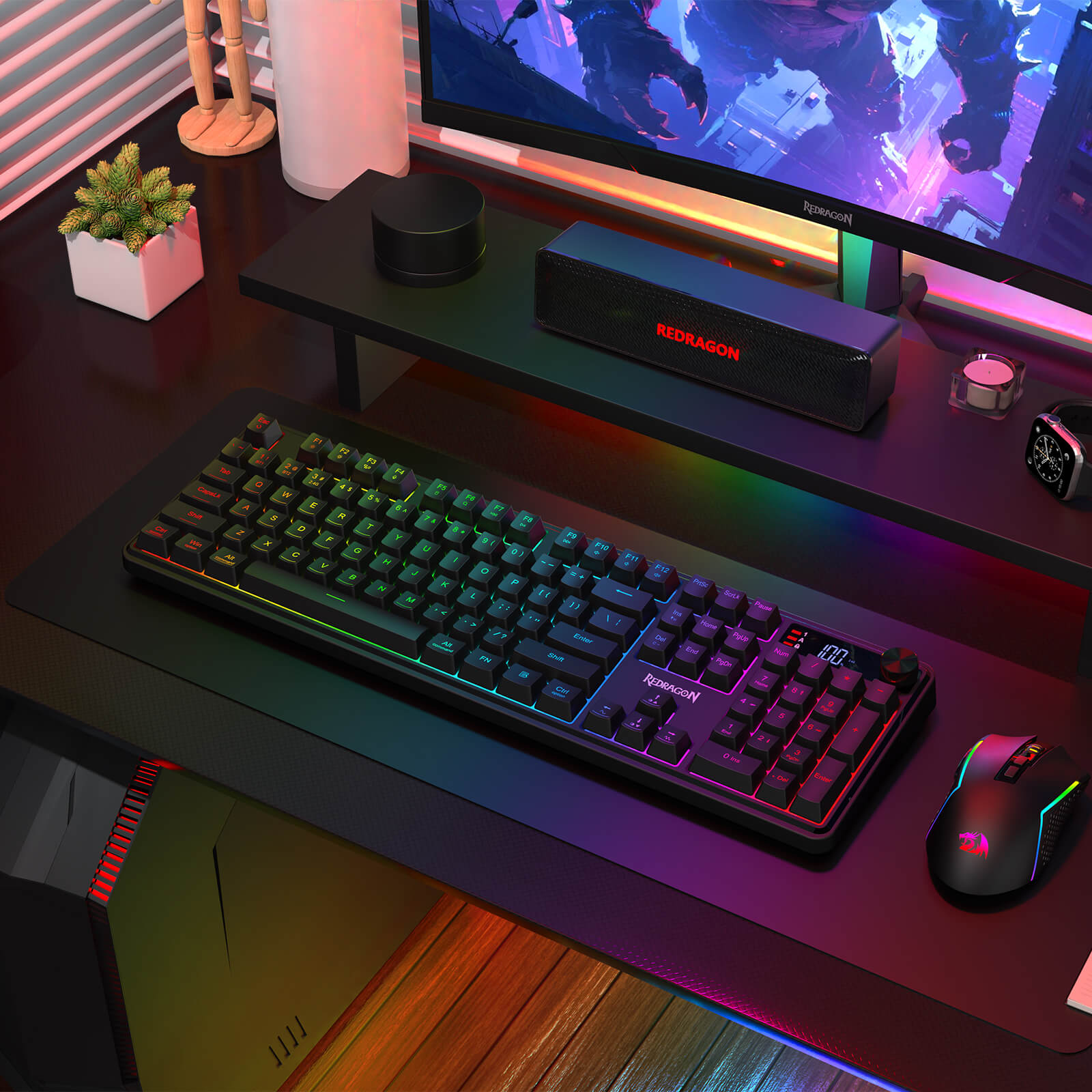 The Redragon RM104 Pro keyboard and RM104 mouse are displayed in a vibrant RGB-lit gaming setup, with a monitor, speakers, and a small potted plant.