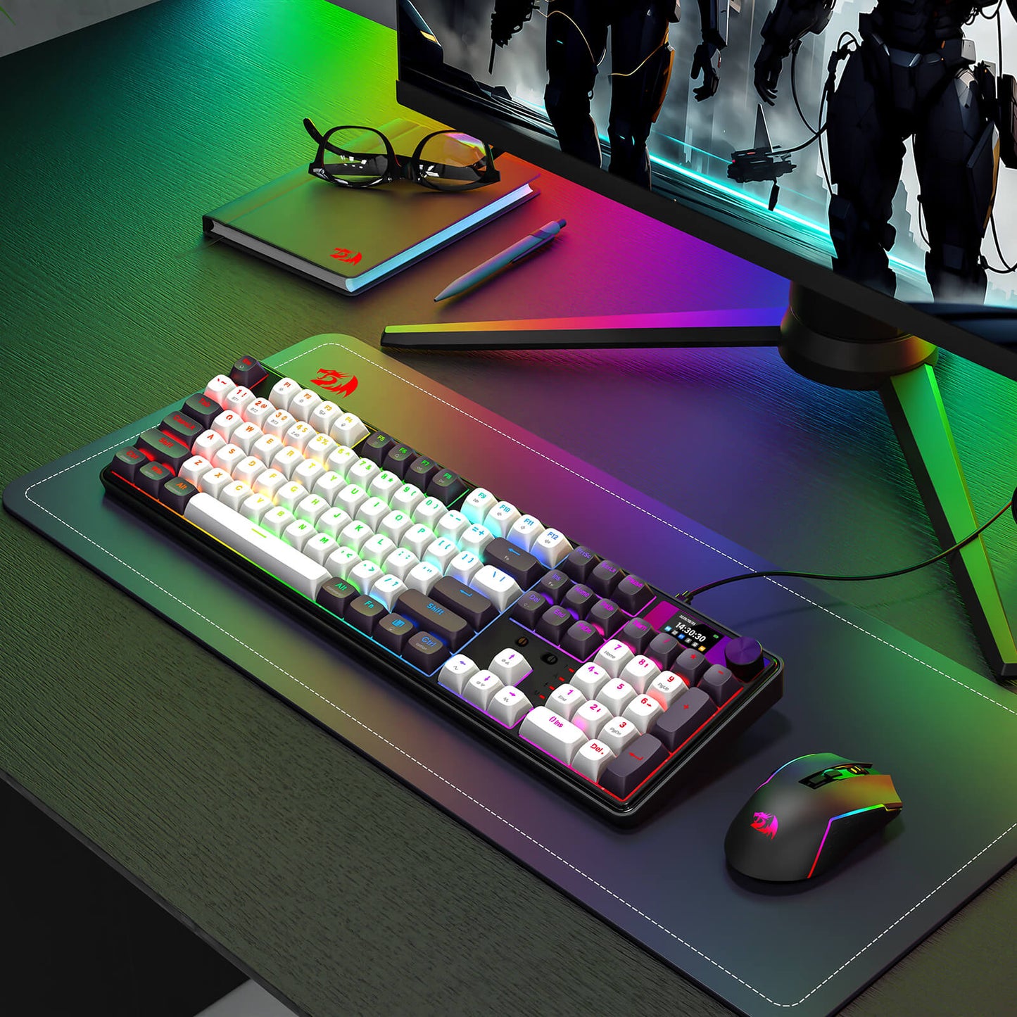 Gaming setup with keyboard, mouse, and monitor on a desk with RGB lighting.