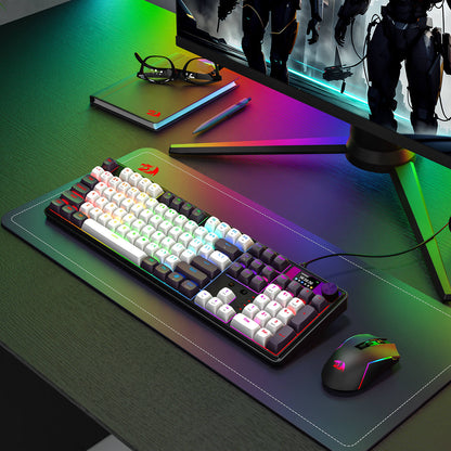 Gaming setup with keyboard, mouse, and monitor on a desk with RGB lighting.