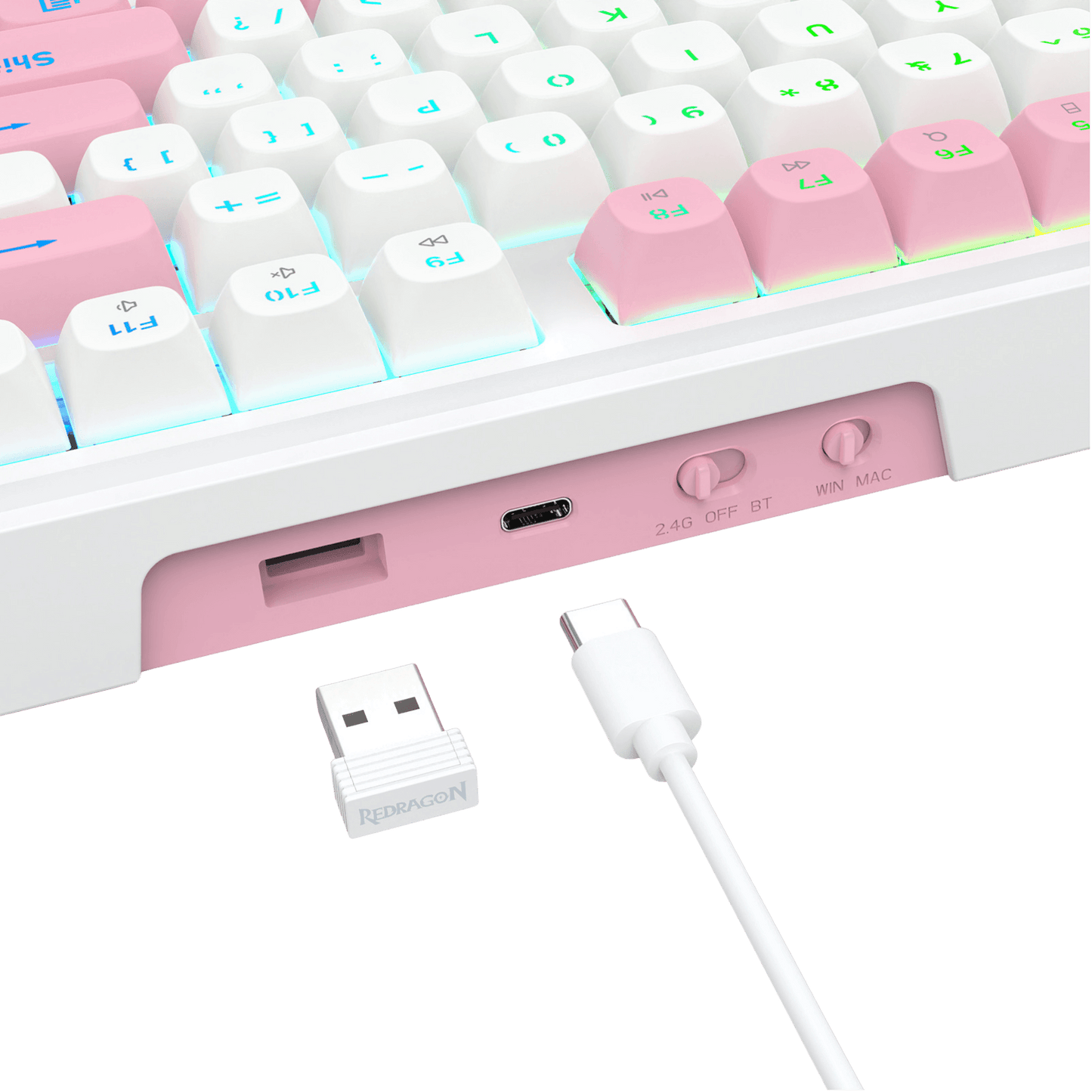 Close-up of a white and pastel pink mechanical keyboard showing the port area, with a small white USB receiver and white cable in front on a clean white background.