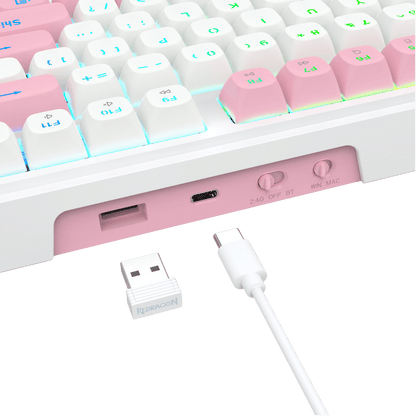 Close-up of a white and pastel pink mechanical keyboard showing the port area, with a small white USB receiver and white cable in front on a clean white background.