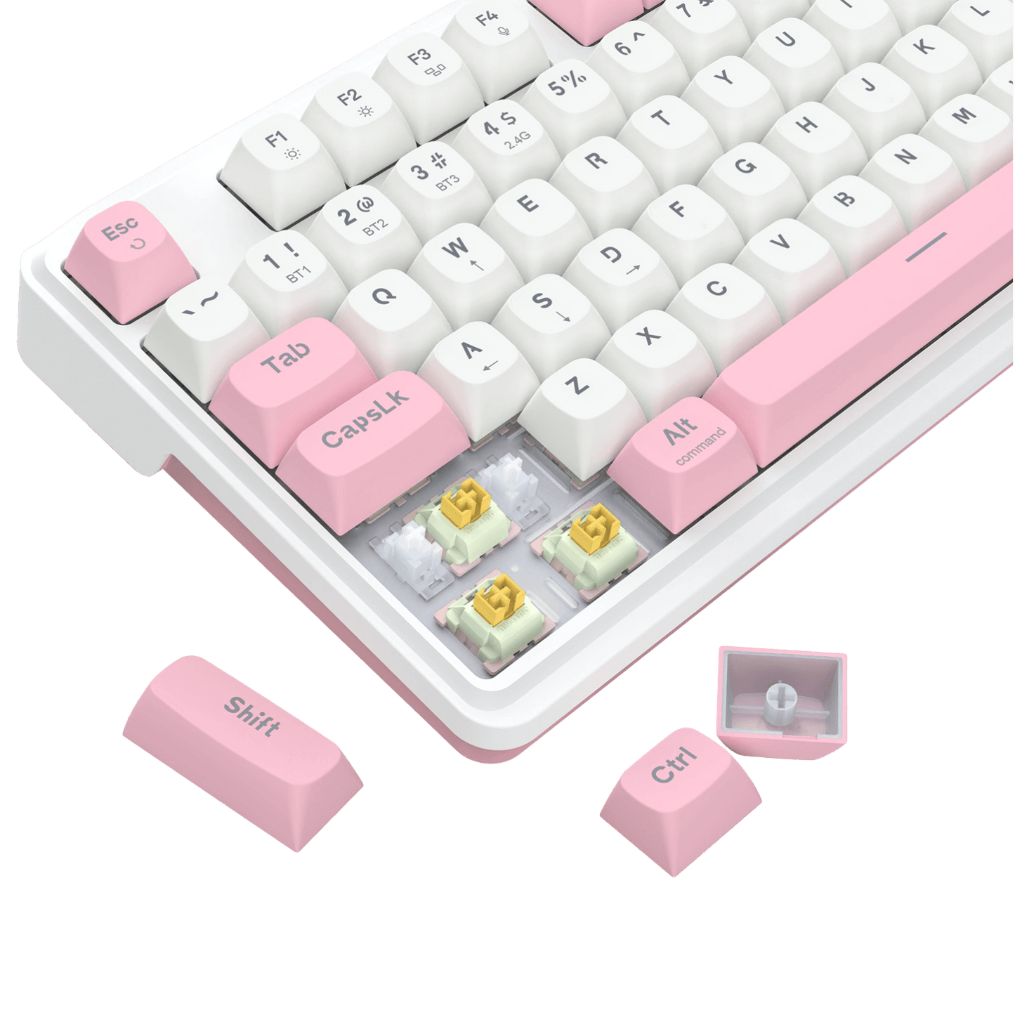 A close-up of a mechanical keyboard with white keycaps, pastel pink accent keys, and exposed switch capsules showing gold and mint contacts. Several loose pink keycaps are arranged around the keyboard on a clean white background.