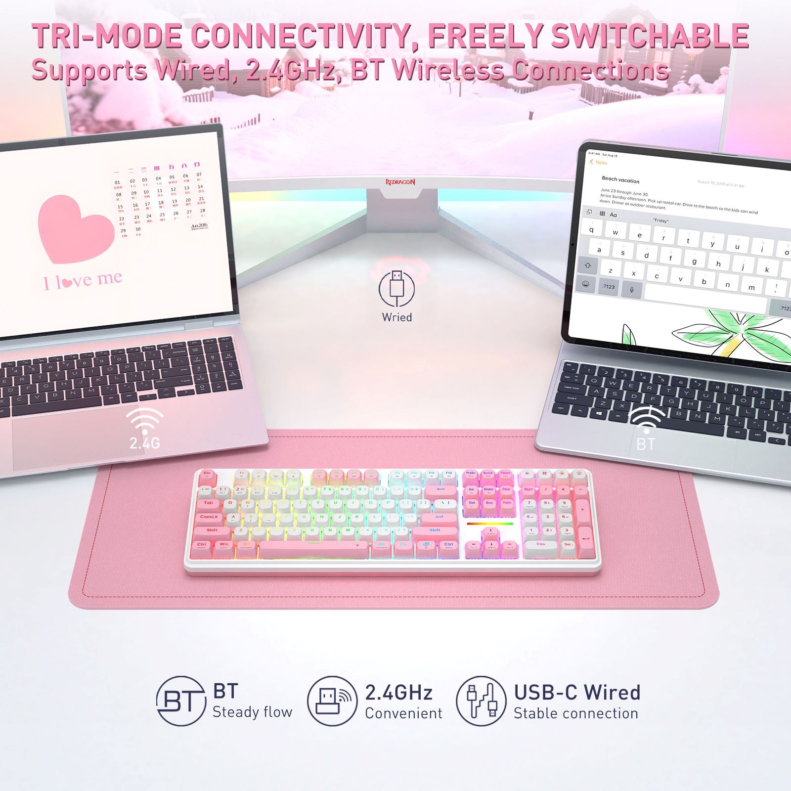 A pastel rainbow mechanical keyboard displayed on a pink desk mat, with two laptops in the background showing screens and feature callouts for wired, 2.4GhBT wireless, and USB-C wired connectivity.