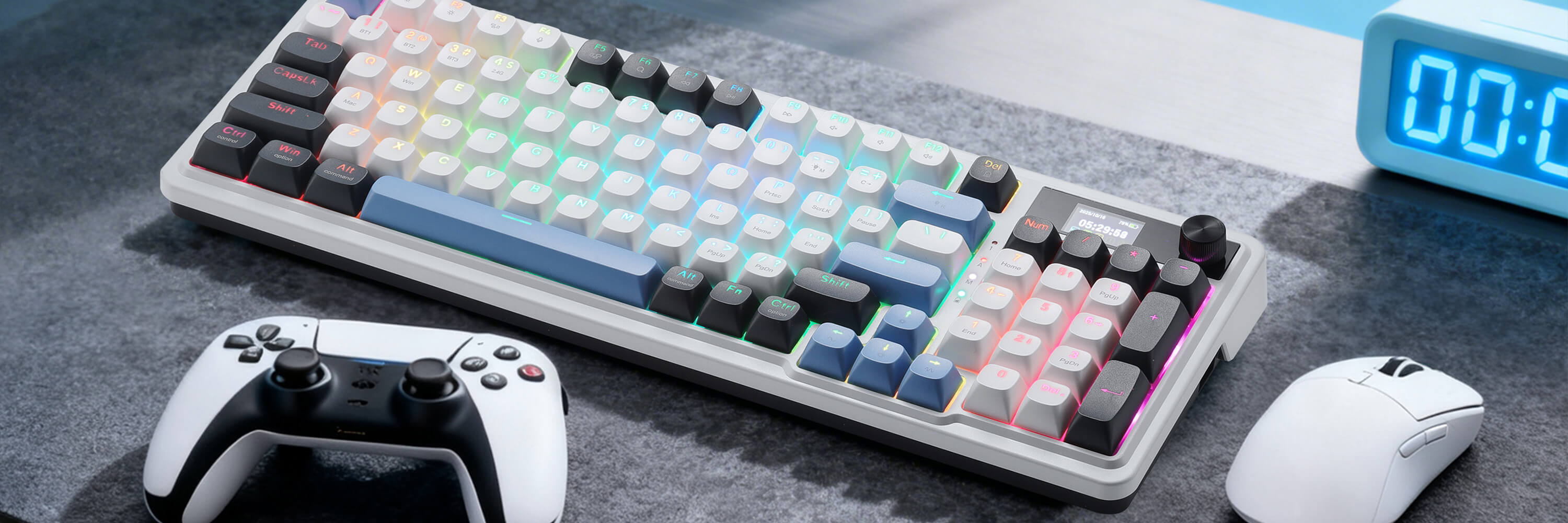 Redragon K719 Mechanical keyboard with RGB backlighting, gaming controller, and mouse on a gray surface.