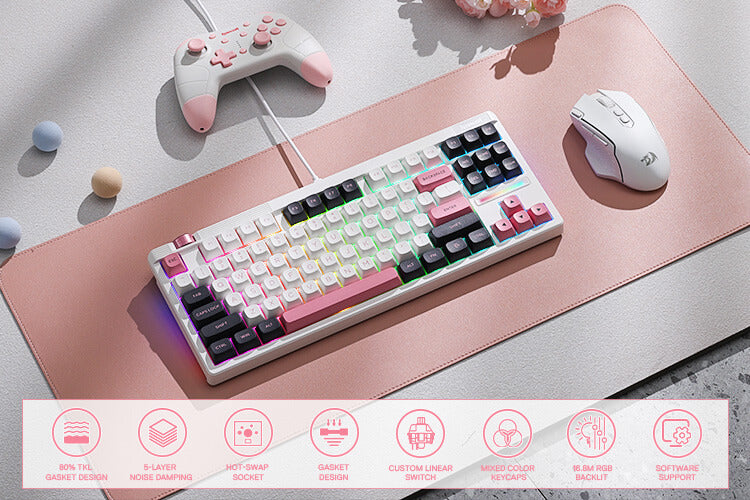 Redragon Mechanical keyboard with pink and black keys on a pink mouse pad, surrounded by gaming accessories.