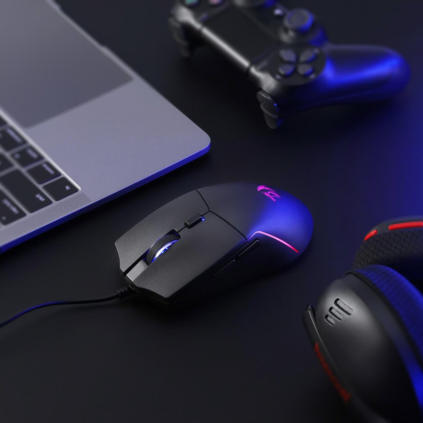 A close-up of the Redragon gaming mouse (with RGB backlighting) is shown on a desk, paired with a laptop, controller, and headset to highlight its fit in a gaming setup.
