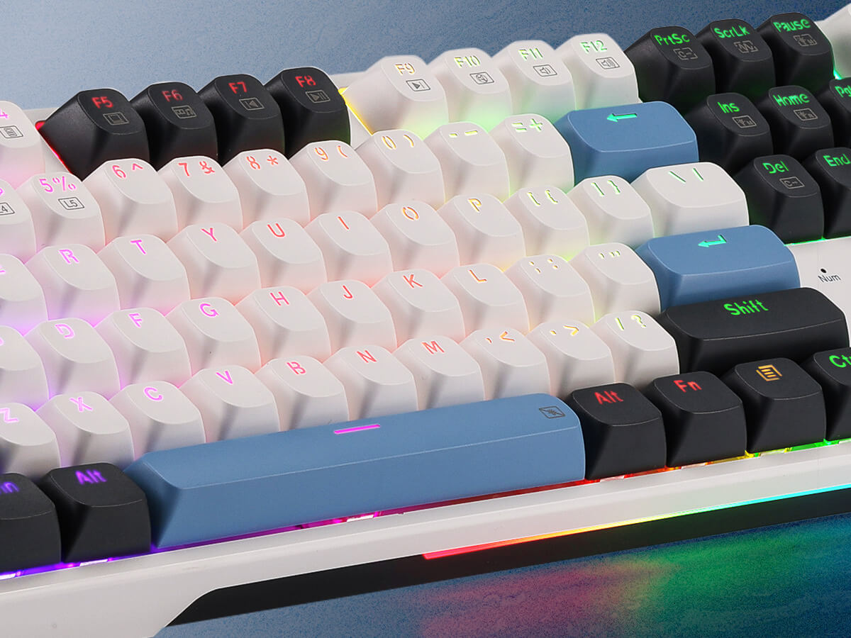 Close-up of a mechanical keyboard with RGB lighting on a blue surface