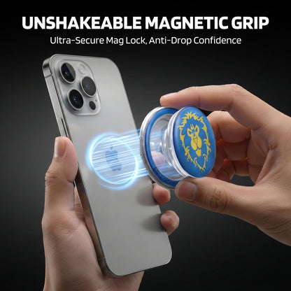 Against a dark background, a hand holds a silver smartphone (with a multi-lens camera) while another hand attaches a blue-and-yellow branded magnetic stand: glowing blue light circles the phone’s back (showing the magnetic connection), with "UNSHAKEABLE MAGNETIC GRIP" and "Ultra-Secure Mag Lock, Anti-Drop Confidence" text at the top.
