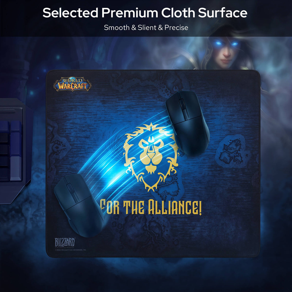 A large dark blue Warcraft-themed gaming mouse pad with a gold lion emblem and the text 'FOR THE ALLIANCE!' shown on a dark promotional background. Two black computer mice are placed on top of the pad, and the top of the image includes the text 'Selected Premium Cloth Surface' with a blurred fantasy character in the background.