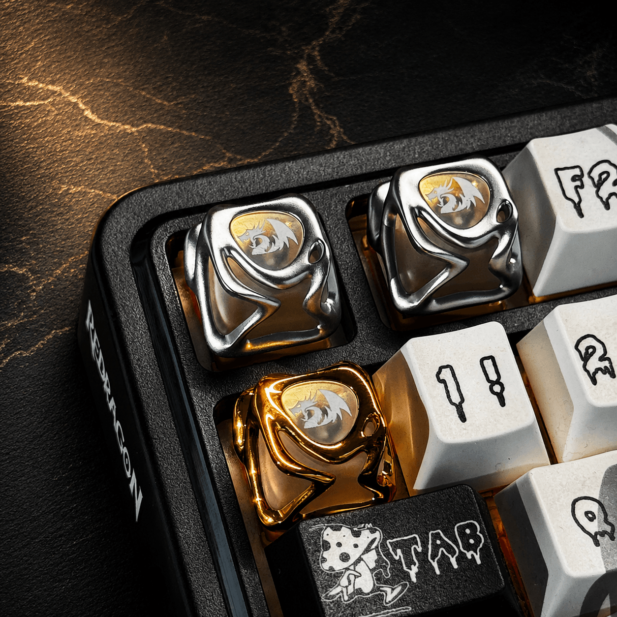 Close-up of mechanical keyboard keys with gold and silver accents on a dark surface.