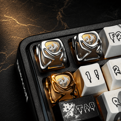 Close-up of mechanical keyboard keys with gold and silver accents on a dark surface.